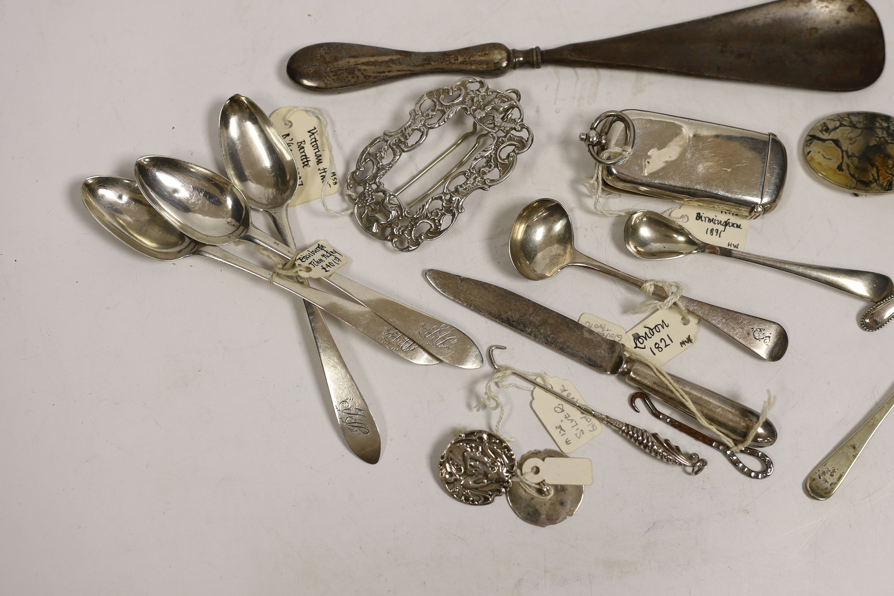 An Edwardian silver combination vesta and sovereign case (a.f.), seven small items of silver flatware, a pair of silver buttons and a silver clip, together with five other items including button hooks, a moss agate brooc